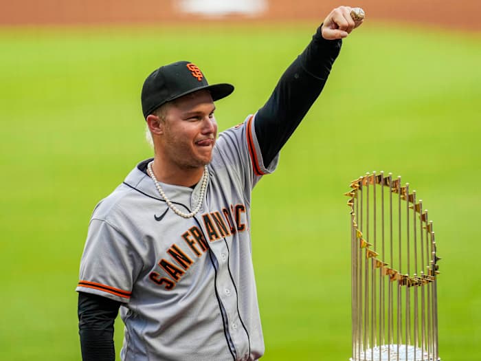 Jun 20, 2022; Cumberland, Georgia, USA; San Francisco Giants left fielder Joc Pederson (23) displays his World Series ring next to the Atlanta Braves 2021 World Series trophy after a ceremony before the game at Truist Park.